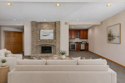 Lower level features wood burning fireplace and walk up wet bar, perfect for entertaining