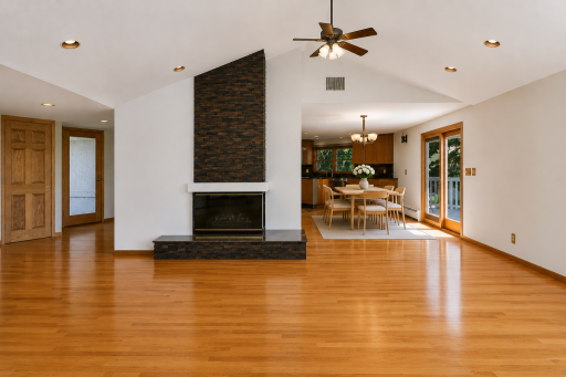 Vaulted great room with floor to ceiling stacked stone gas fireplace