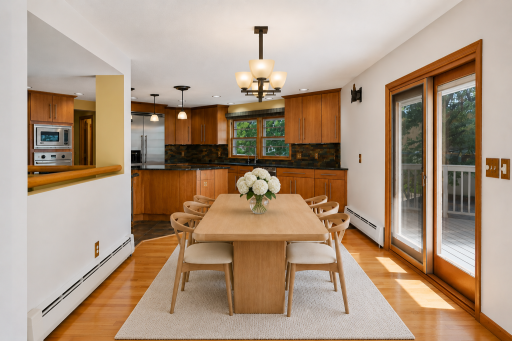 Formal dining space has sliding door access directly to deck overlooking Halstead Bay