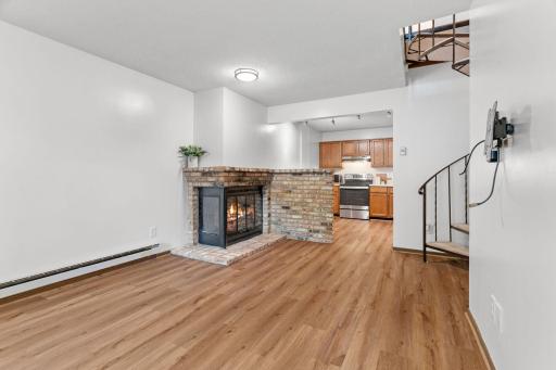 Greeted by updated flooring throughout the main level (2024) and a charming brick, wood burning fireplace.