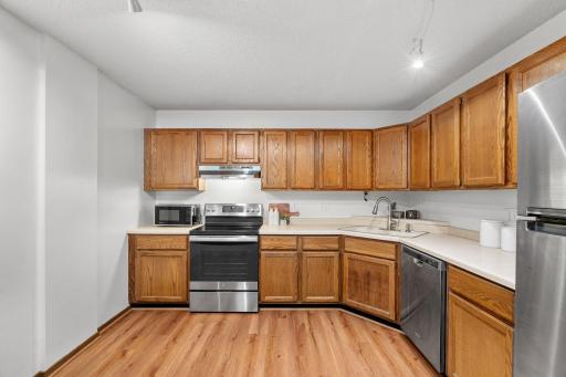 Modern kitchen with tons of cabinet space and stainless steel appliances.