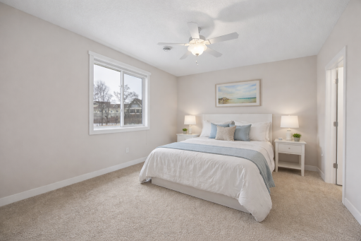 Staged Primary Bedroom. This spacious bedroom features abundant natural light and a neutral color palette.