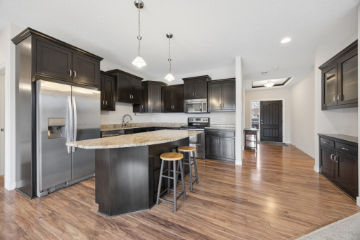 Kitchen with a built in side butler, large island, stainless steel appliances