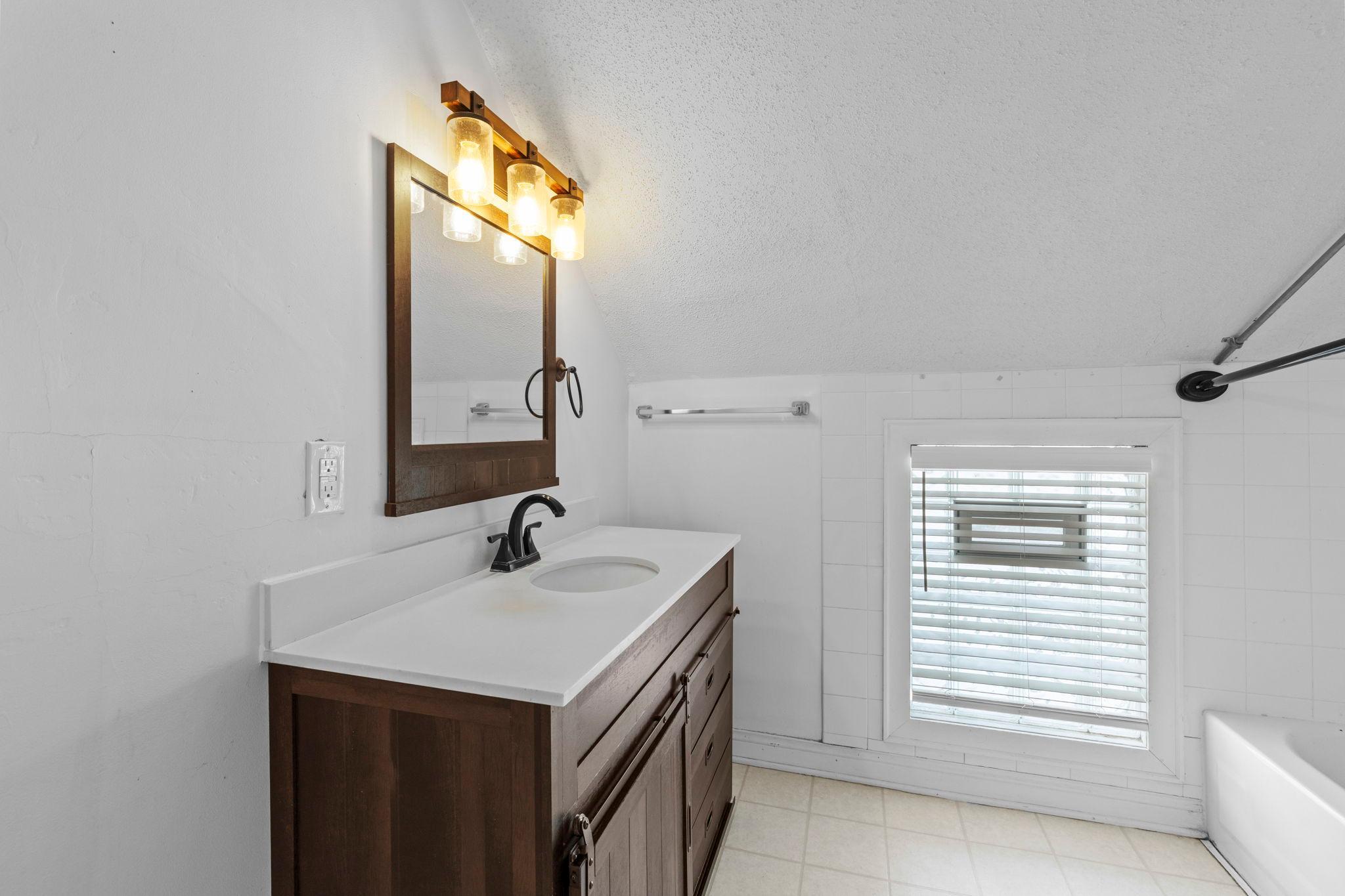 Upper level full bath with newer bathroom vanity