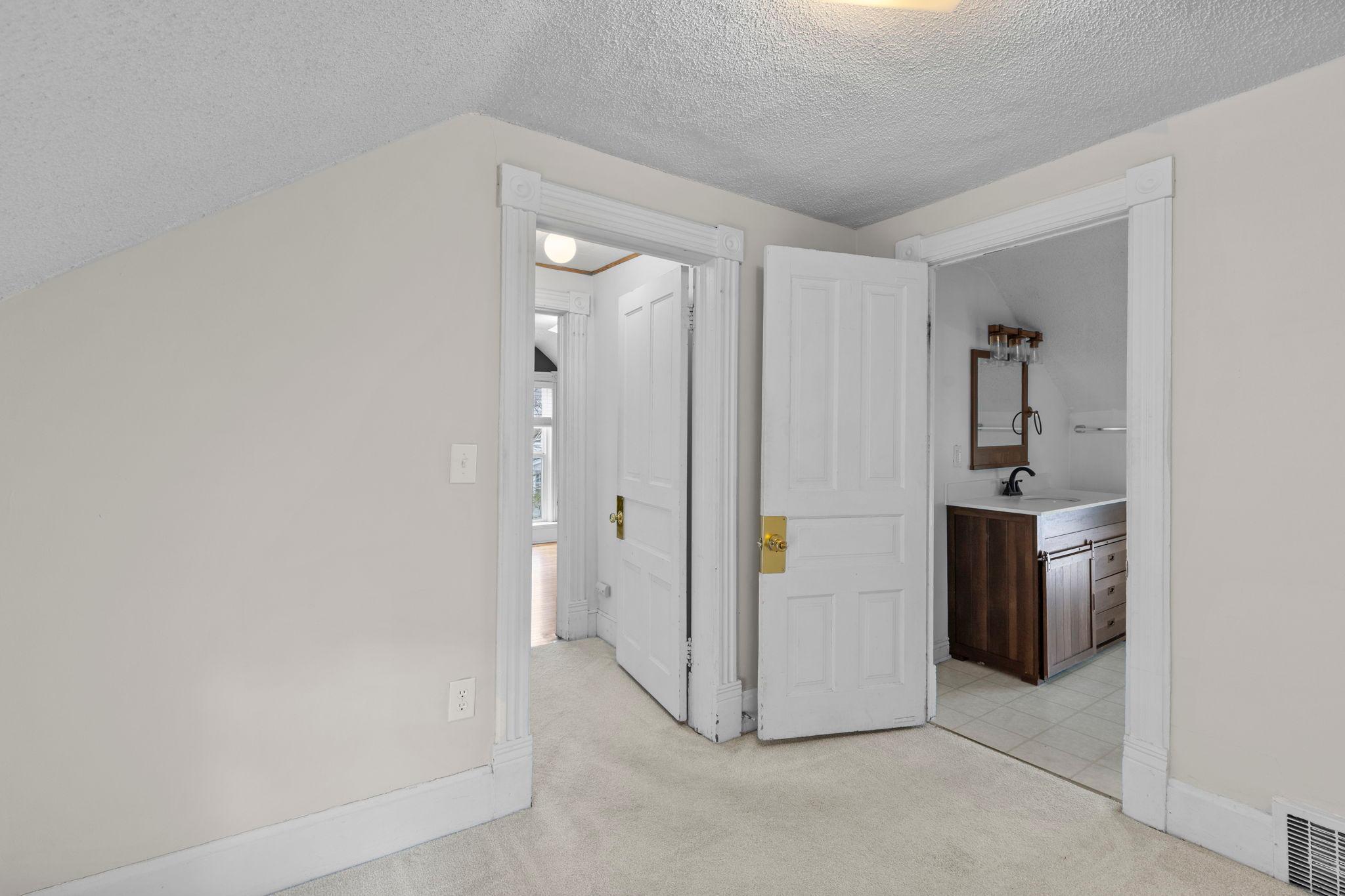 Outside the upper level bedroom is an updated bathroom & loft space