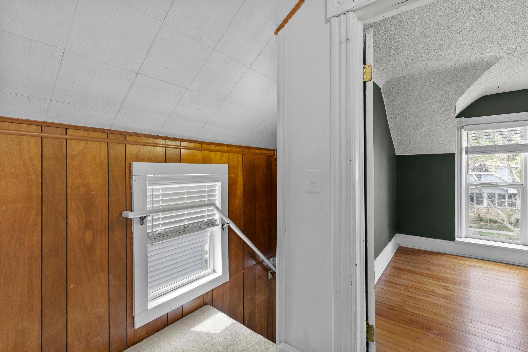 Up the stairs leads to the front unit primary bedroom