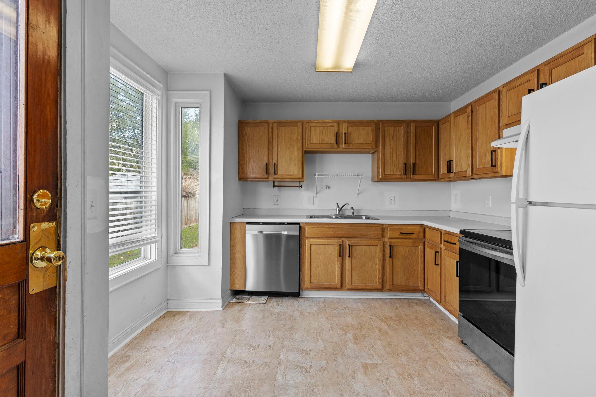 Kitchen features newer stove/oven, dishwasher and updated flooring