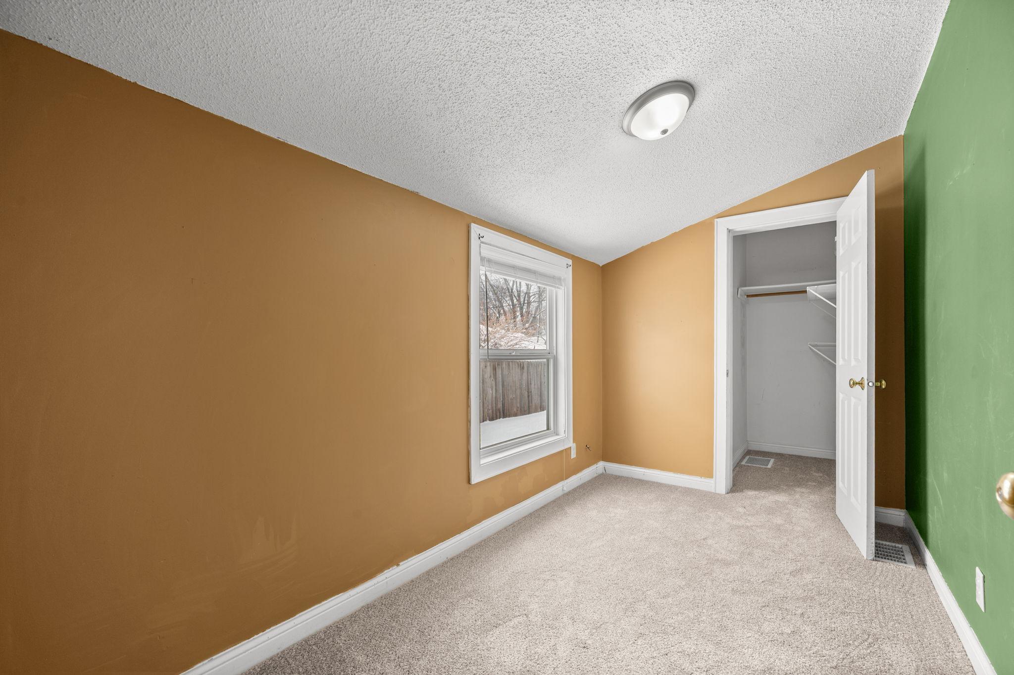 Back unit main level bedroom with walk-in closet
