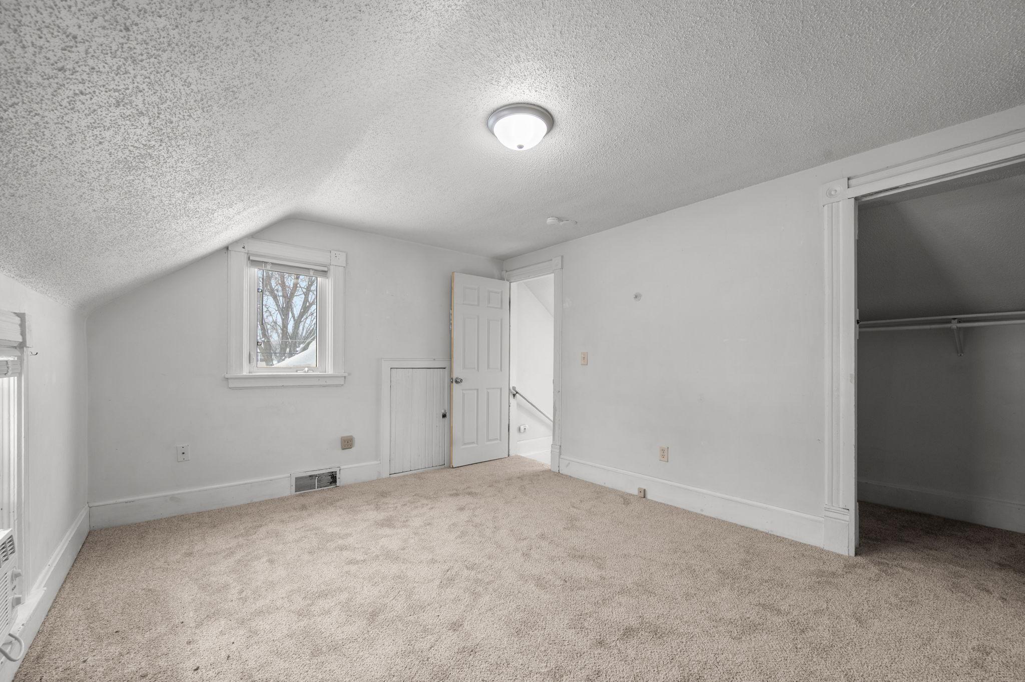 Upper level bedroom with walk-in closet & new carpet
