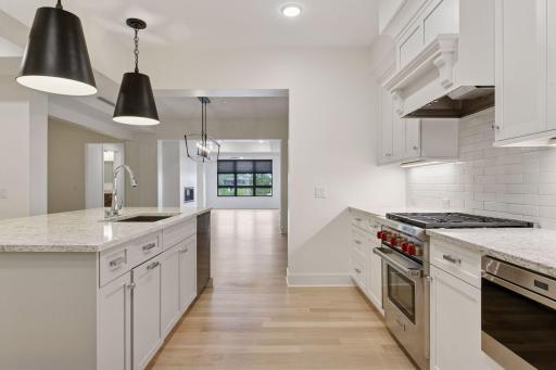 Kitchen flows seamlessly into the dining and living spaces.