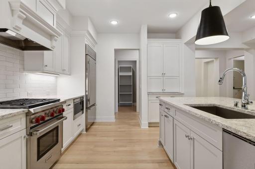 Kitchen highlights include high-end SS appliances, gas range, tiled backsplash, plenty of cabinet space, and a walk-in pantry for storage