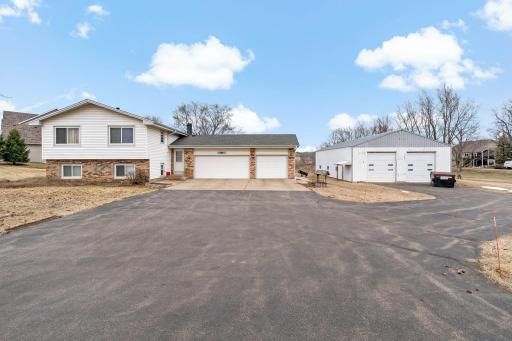 Asphalt driveway, concrete in front of home's three-stall garage.