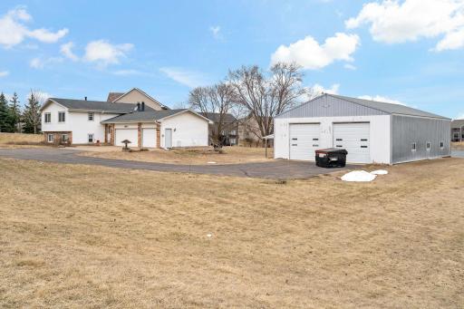 Side view of house with attached 36' x 21' 3-stall extra-deep garage; and outbuilding with double overhead12-ft doors.