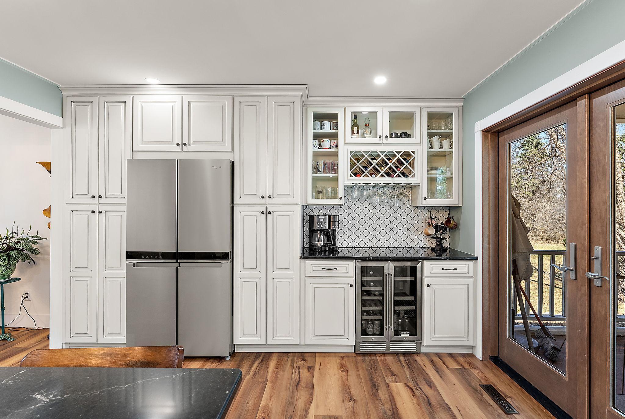The expanded kitchen features a coffee & wine bar and abundant cabinet space