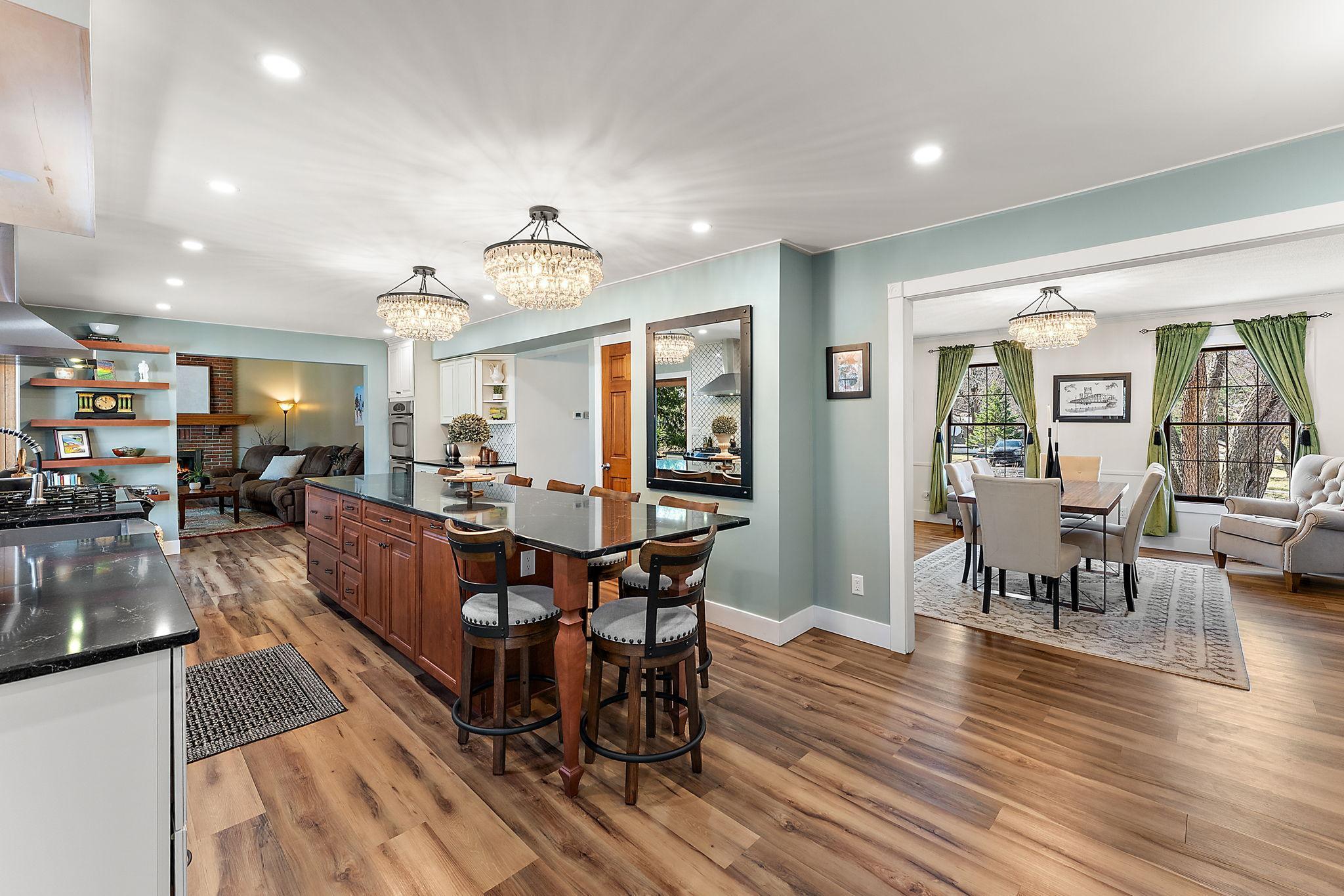 The recently remodeled kitchen features an 12 ft island, new flooring, appliances and much more