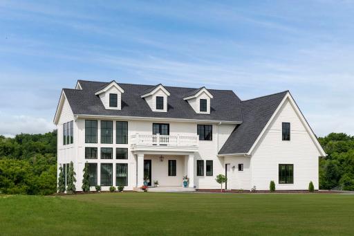 Elegant exterior highlighting timeless architecture, expansive windows, and peaceful views of the surrounding.