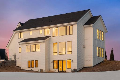 Dramatic twilight exterior showcasing the homeâs scale, expansive windows, and beautiful evening ambiance.