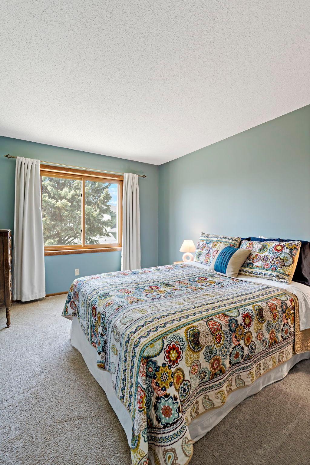 Primary bedroom offering a full walk-in closet