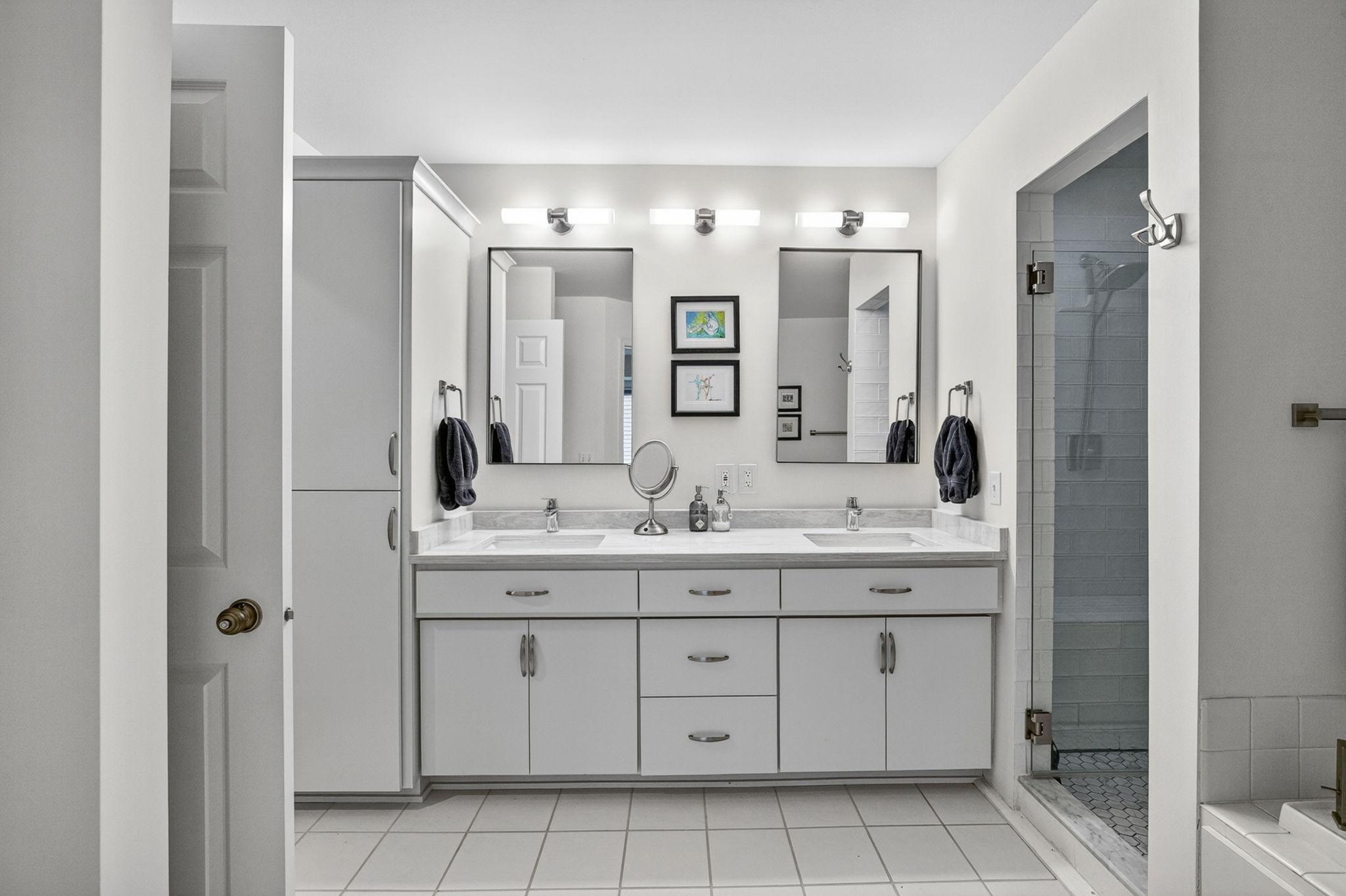Bathroom features dual sinks and double vanity