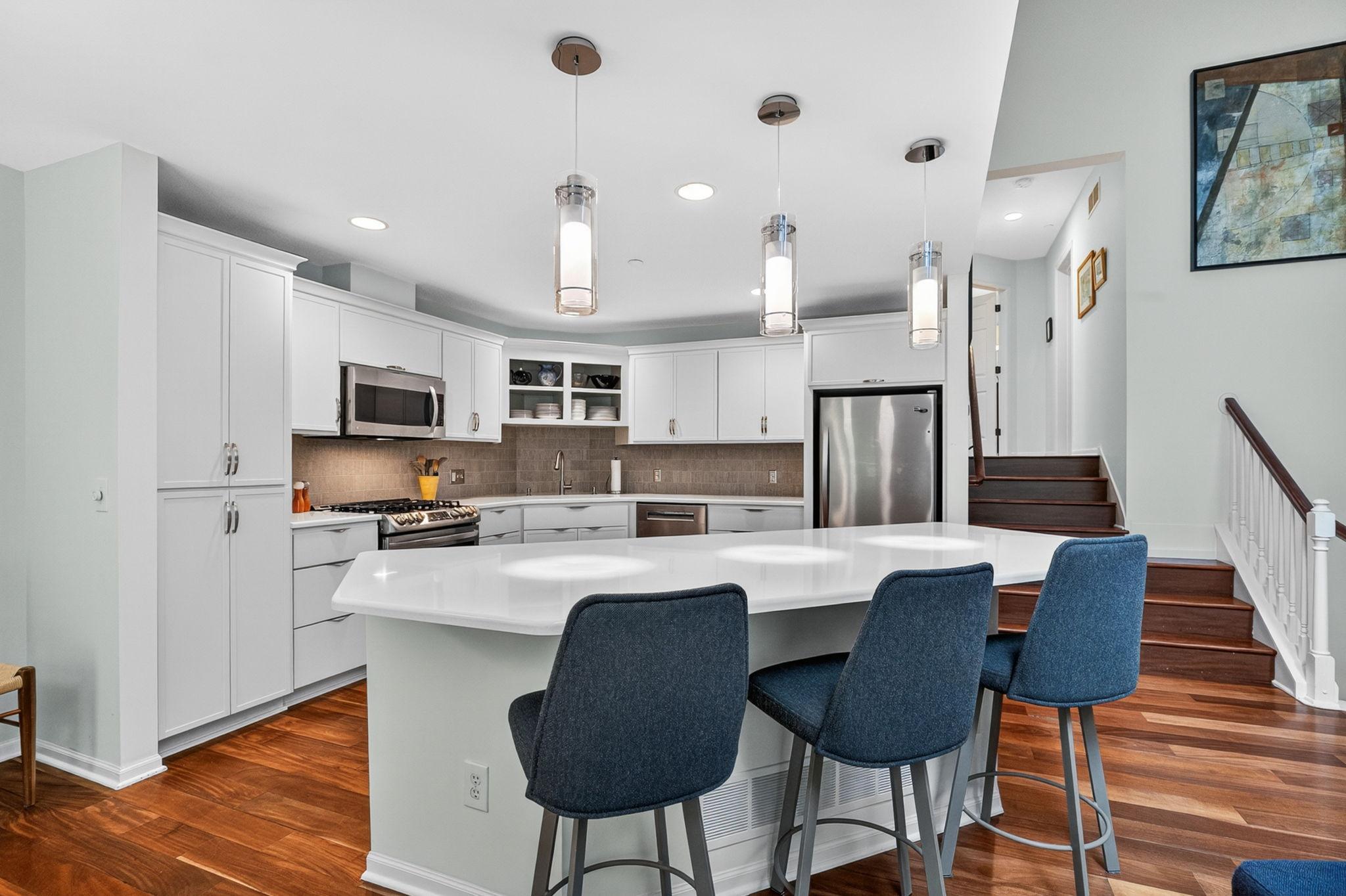 Spacious kitchen with stainless steel appliances, large center island, and ample cabinetry