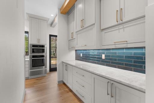 Butler's pass with thoughtful built in storage and counter space