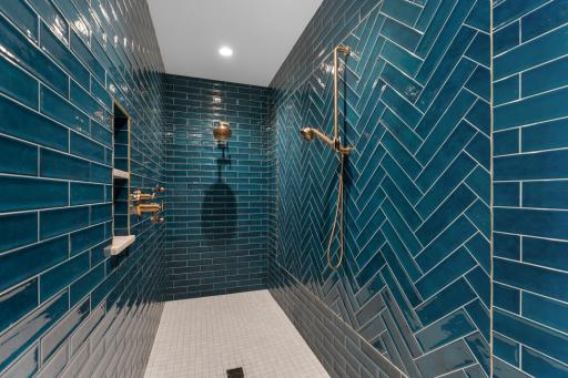 Primary custom tiled shower with dual fixtures