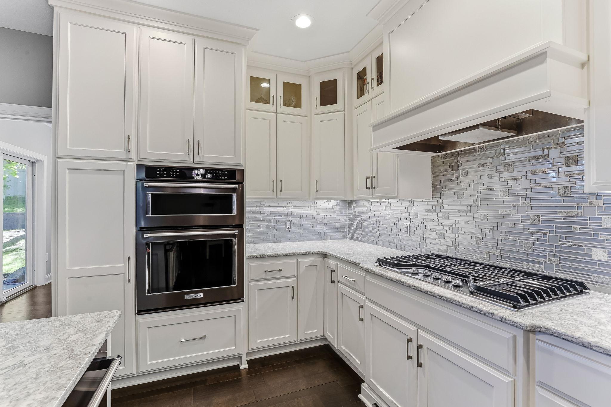 Kitchen features stainless steel appliances including refrigerator, stove top, oven, dishwasher and microwave.