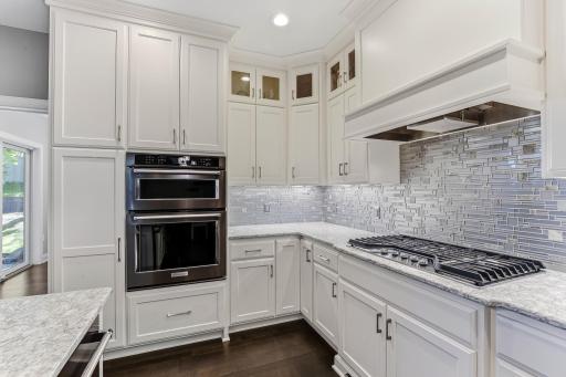 Kitchen features stainless steel appliances including refrigerator, stove top, oven, dishwasher and microwave.