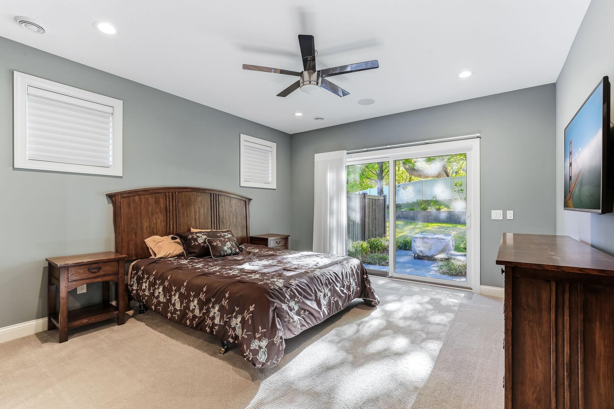 Master Bedroom features sliding glass door to the patio with ceiling fan