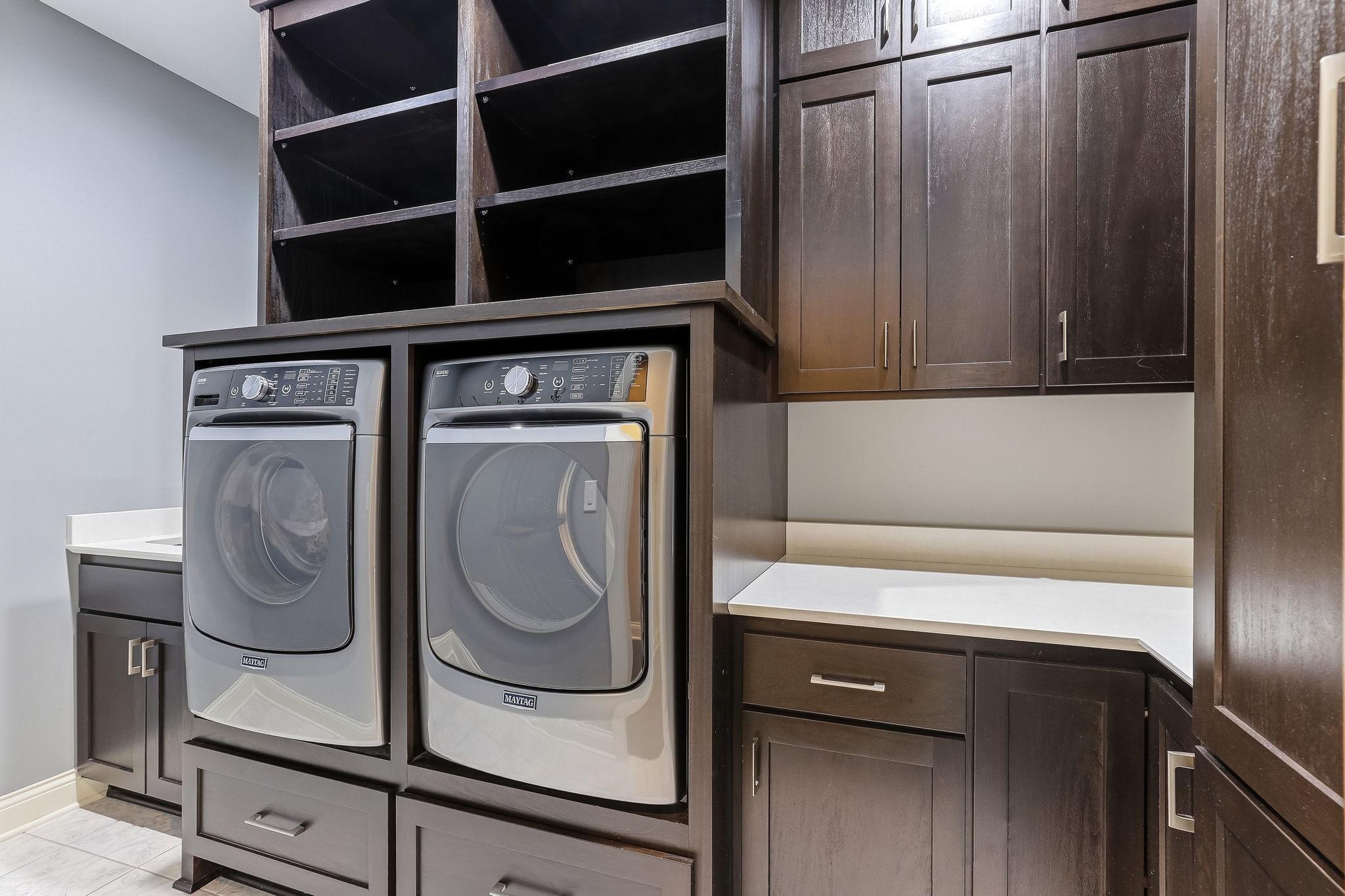 Laundry Area features built in cabinets with lots of counter and storage space! Washer / Dryer