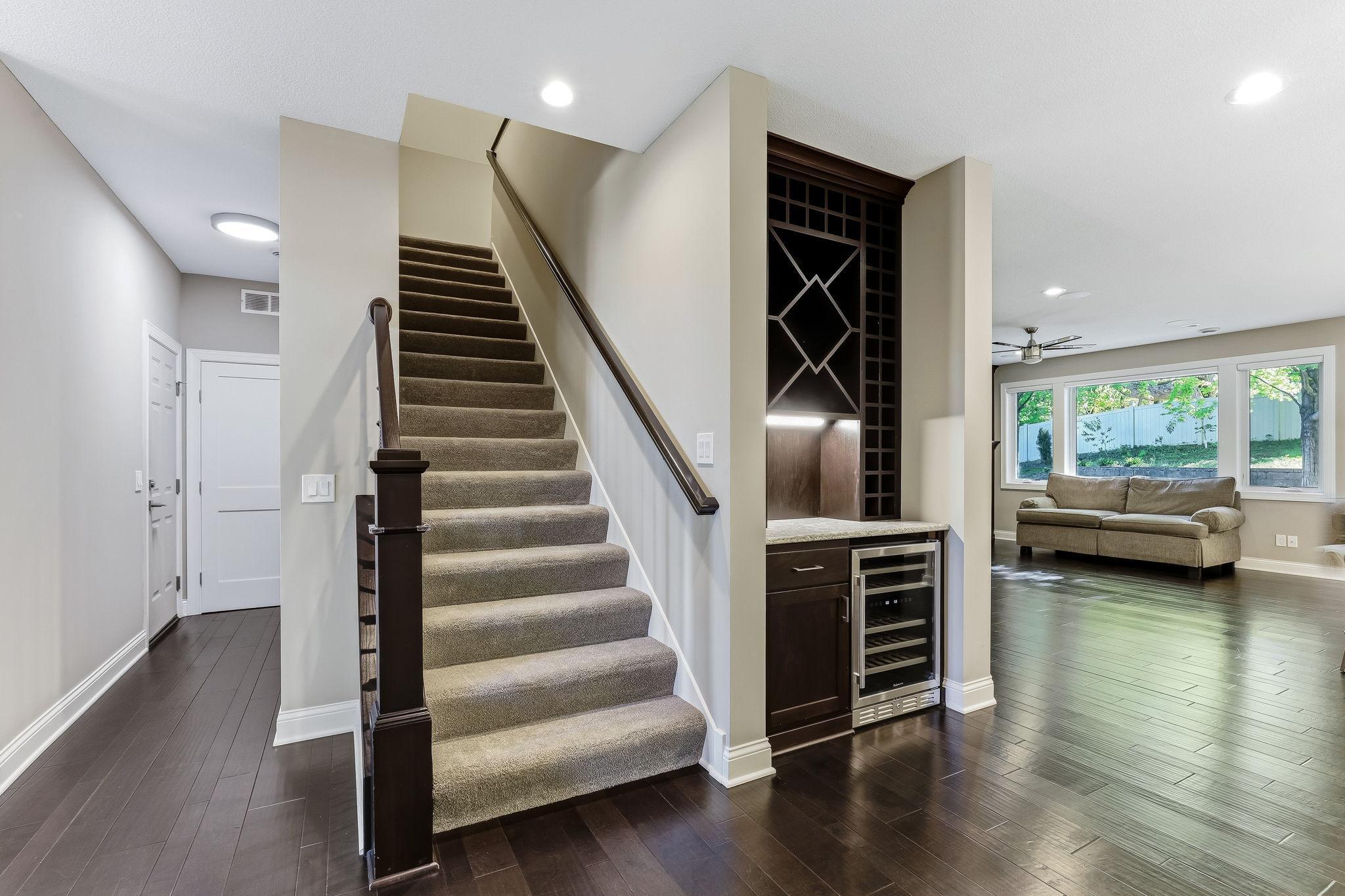 Custom built-in mini bar with wine storage, beverage refrigerator and storage space.