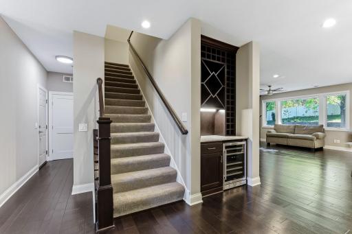 Custom built-in mini bar with wine storage, beverage refrigerator and storage space.