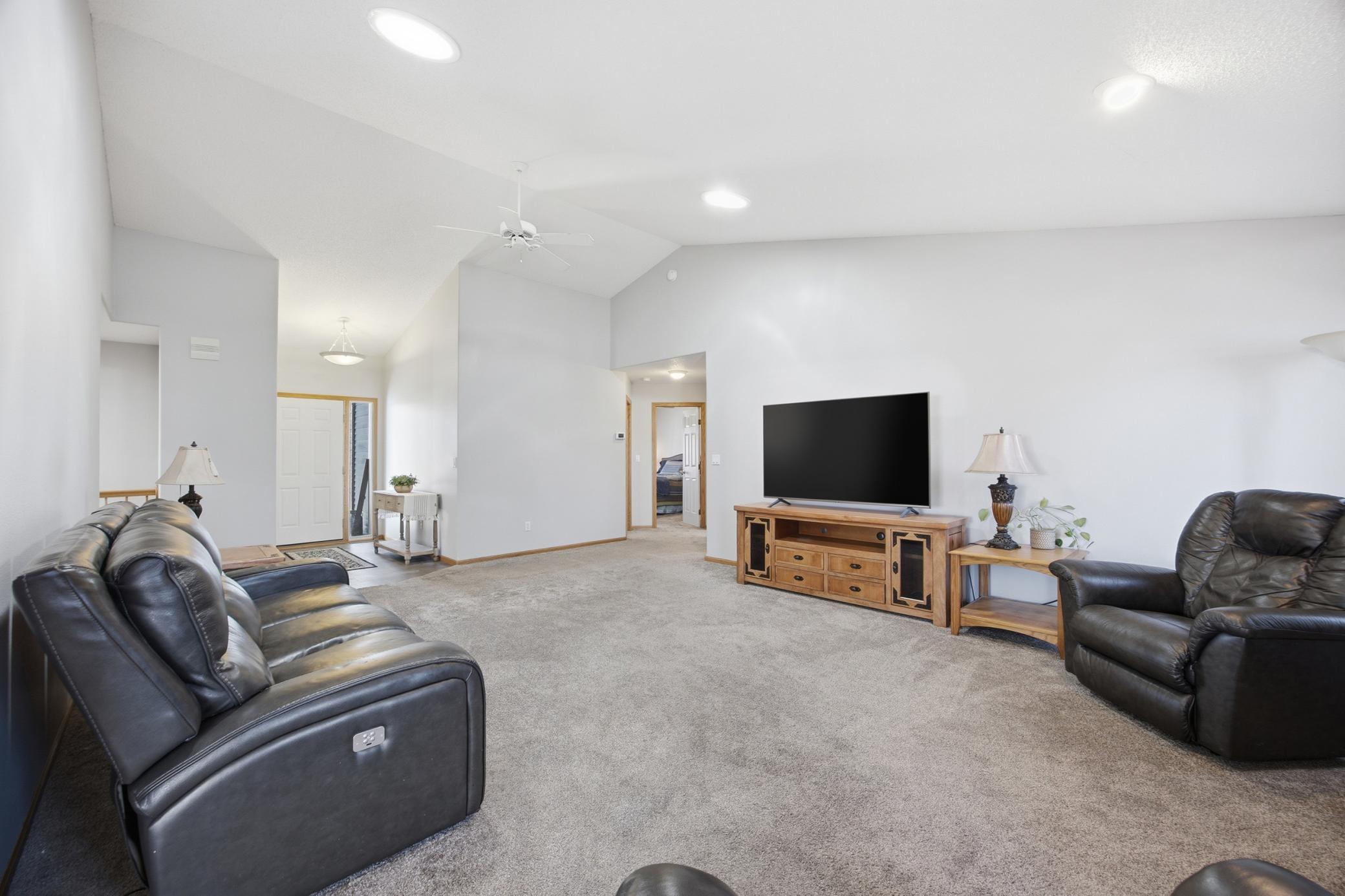 Living Room Featuring Gas Fireplace and 2 Tubular Skylights