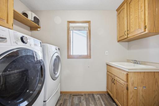Main Floor Laundry & Half Bath with Cabinets and Laundry Sink