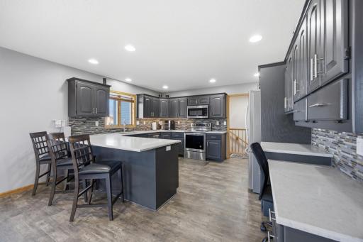Kitchen with Quartz Counter tops, Tile Backsplash and Plenty of Cabinets