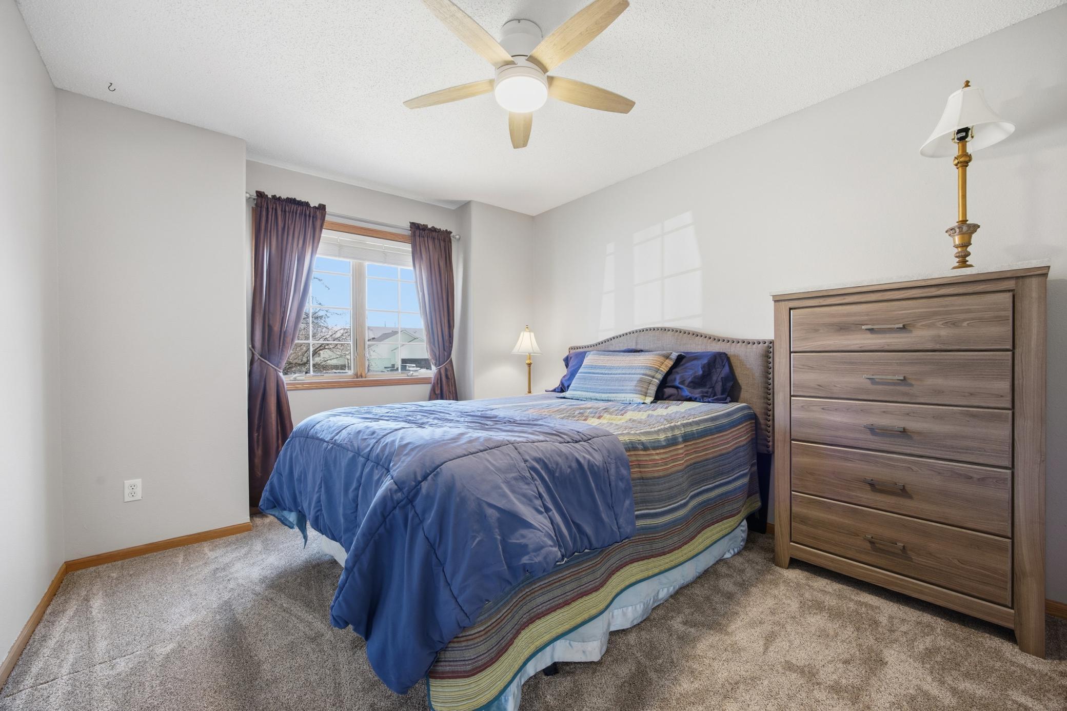 Upstairs Bedroom # 2 with new ceiling fan and carpet