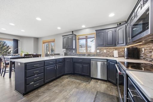 Kitchen with Quartz Counter tops, Tile Backsplash and Plenty of Cabinets