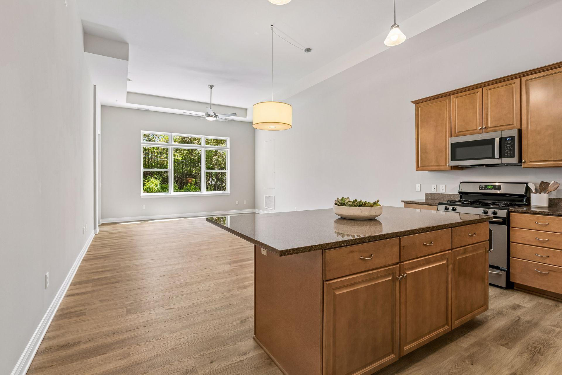 Soaring 12-foot ceilings and oversized windows are a blank slate to make the space fit your lifestyle. Add bar stools for casual dining...