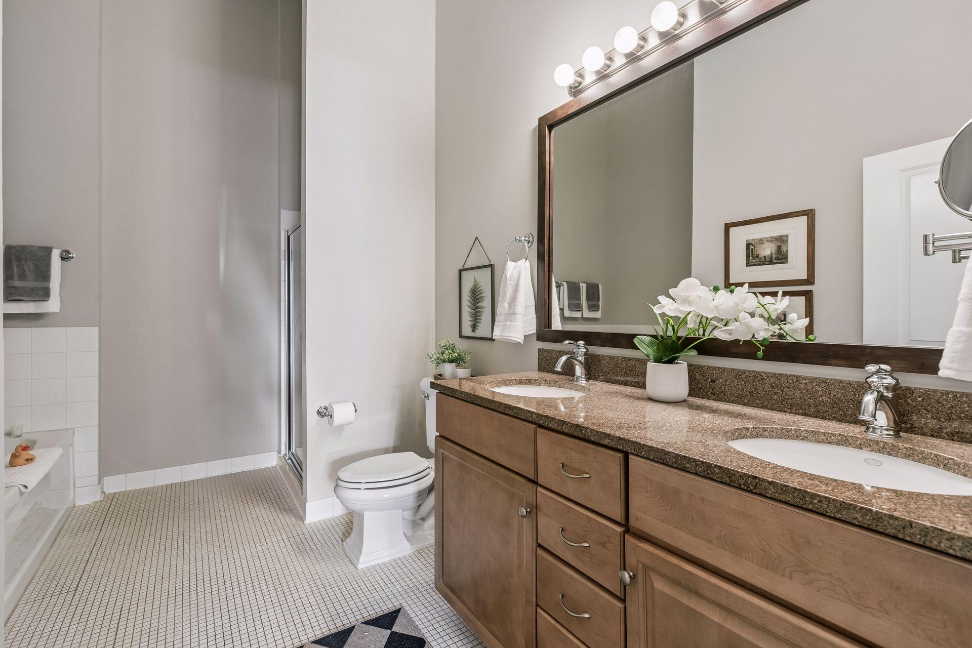 Your primary bathroom makes mornings easy with a dual vanity, tub and walk-in shower.