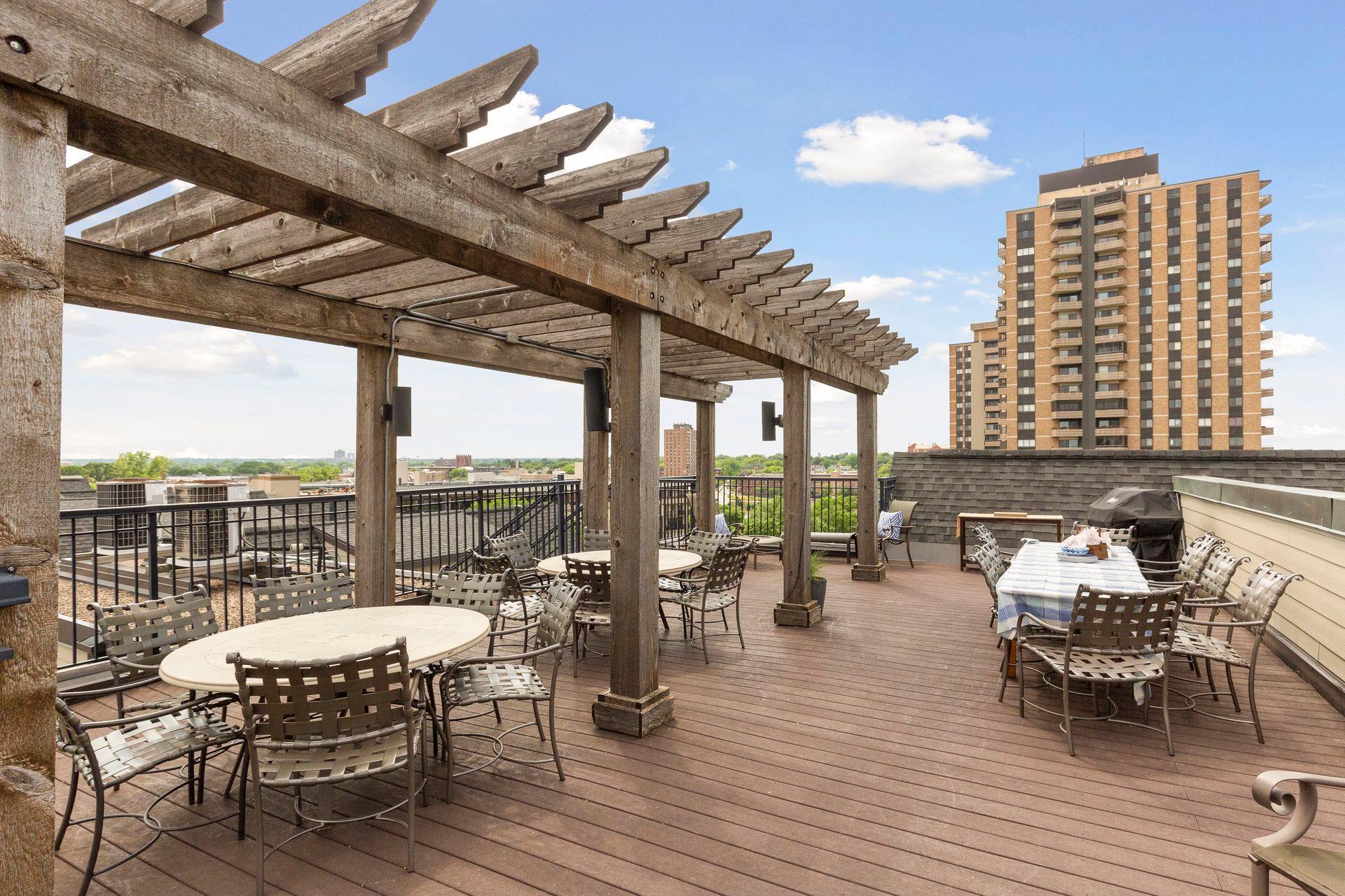 The common rooftop deck includes tables, chairs and a grill...