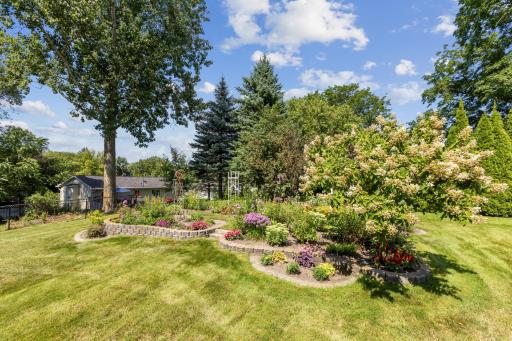 Well-Maintained Exterior with Sprinkler System Supporting Lush Landscaping.