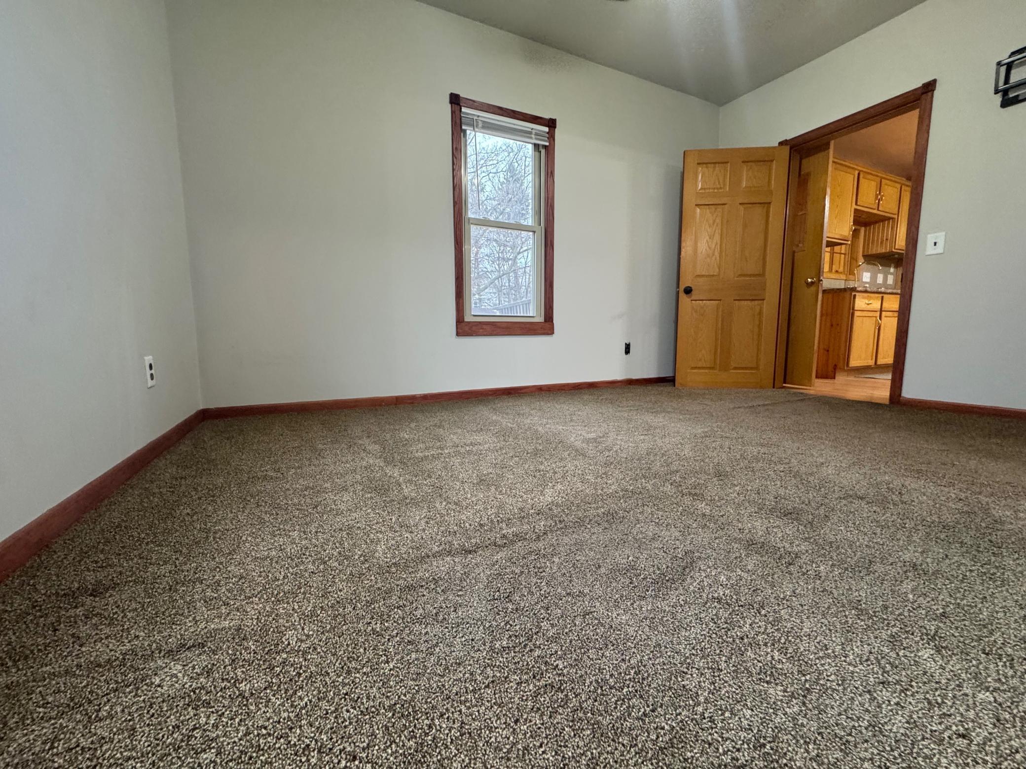 Newer carpet. looks out to backyard