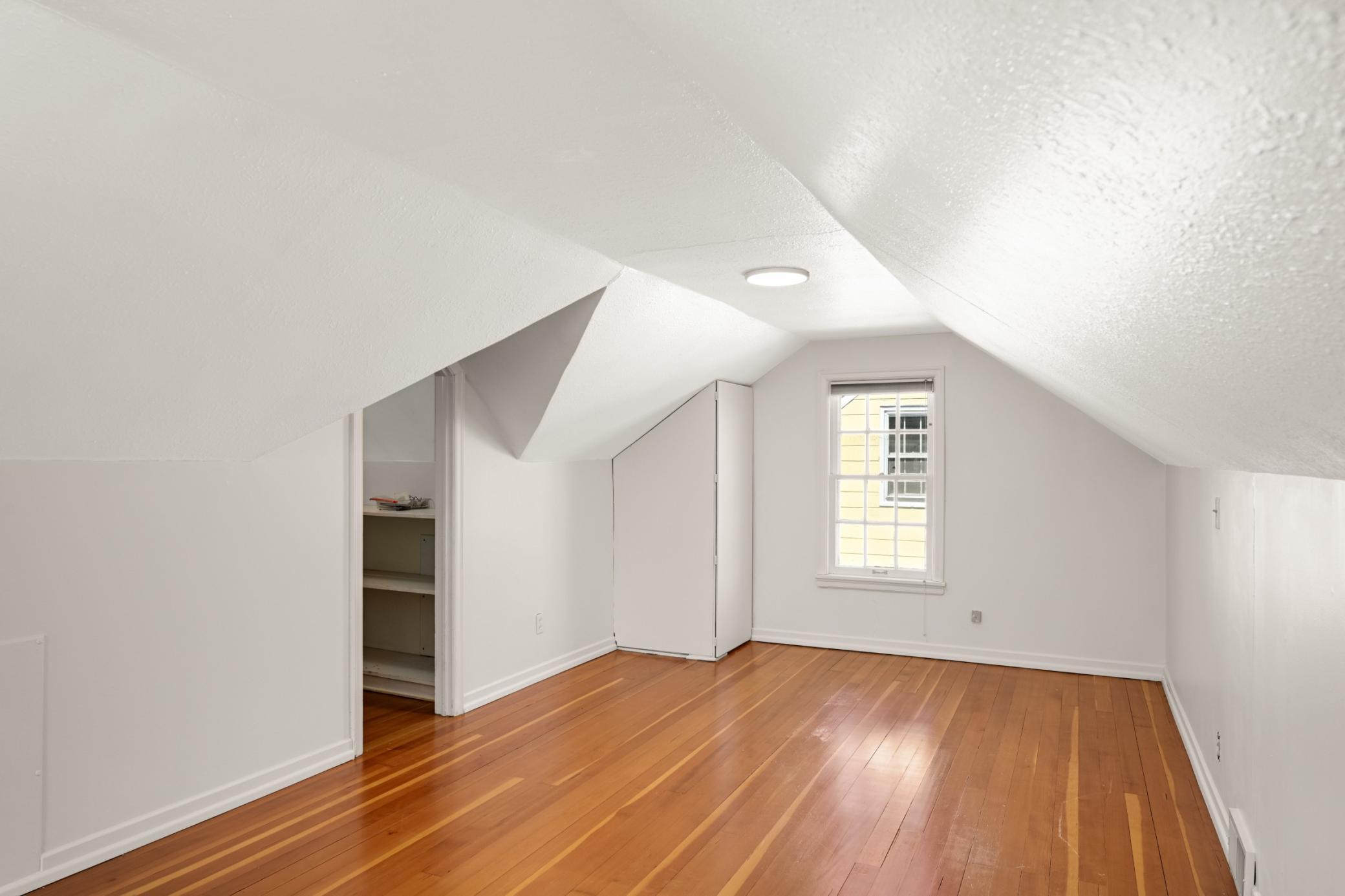 Upper Level bedroom with large walk in closet and fur wood floors