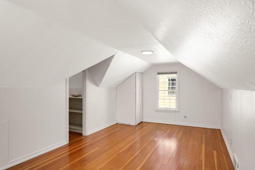 Upper Level bedroom with large walk in closet and fur wood floors