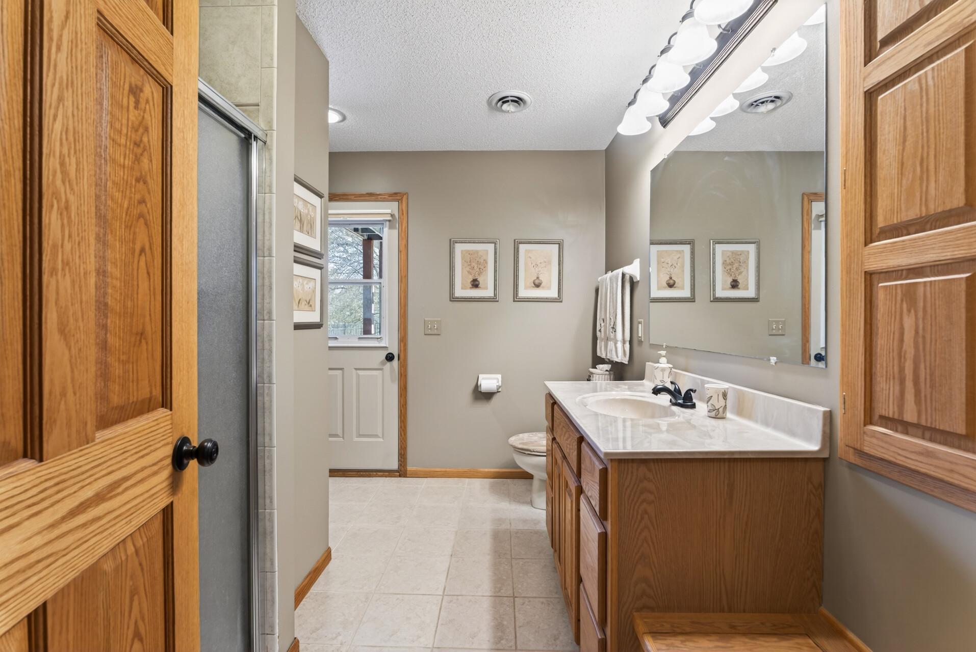 Lower level 3/4 bathroom has walkout access to the patio for convenience coming in from the pool.