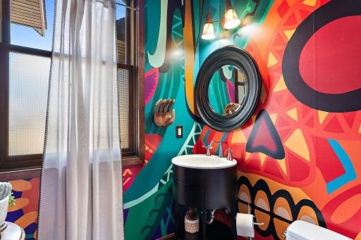 Roomy main floor 1/2 bath with a touch of Picasso! - Wallpaper is a vinyl style paper that is EZ to remove.