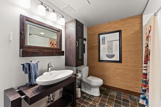 Lower-level bathroom 2 3/4 bath with large shower and bench. This one is equipped to be a steam shower too!
