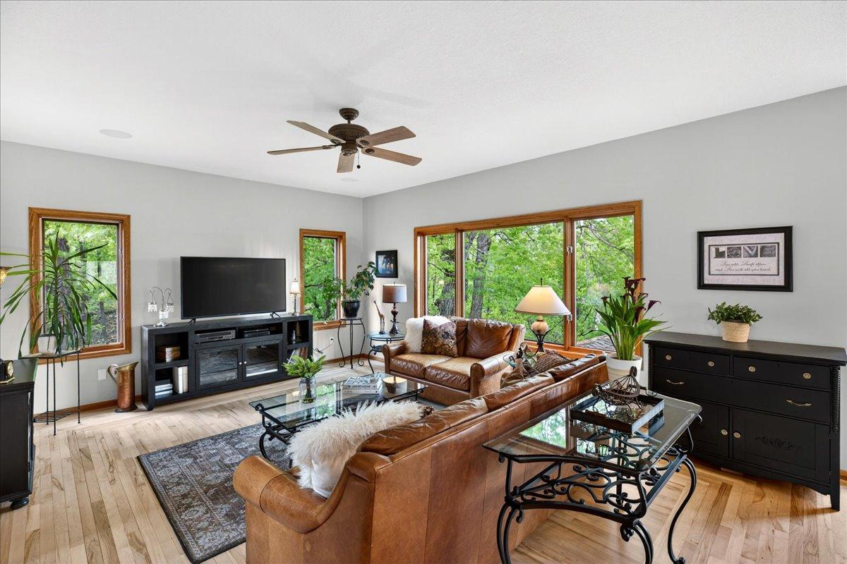 Great Room has maple flooring w/oak inlay. Expansive windows bring in an abundance of natural light and offer wooded views in summer and spectacular color in the fall!