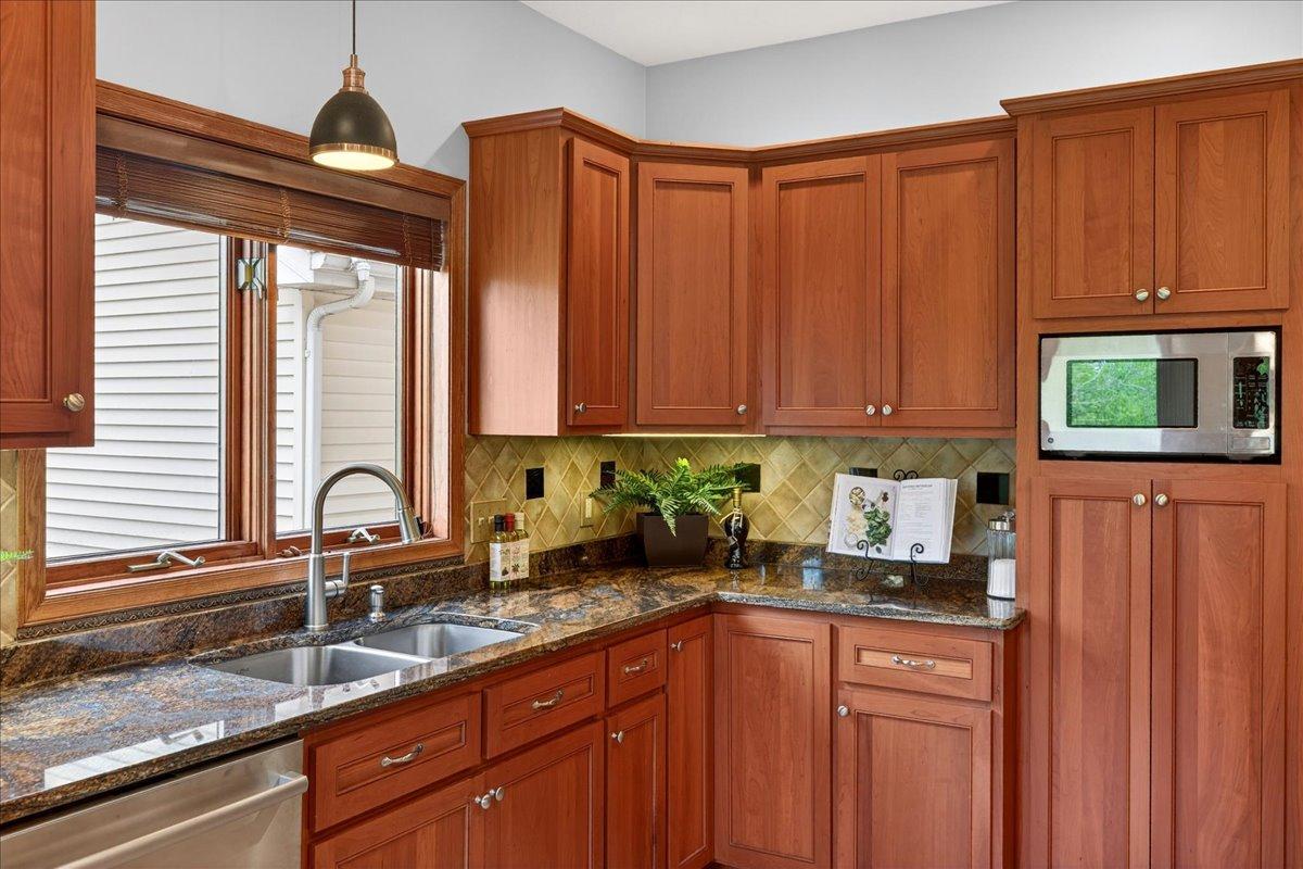 There is a kitchen window for added light, a double stainless steel sink, an updated faucet and custom shade.
