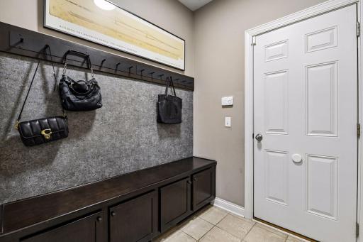 Custom mudroom bench and storage as you enter home from the garage